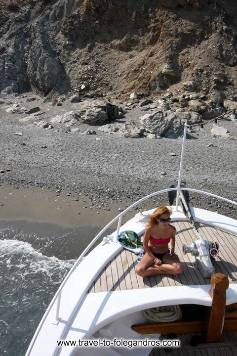 Girl sunbathing on the tour boat at Katergo beach FOLEGANDROS PHOTO GALLERY - Katergo Beach by Ioannis Matrozos