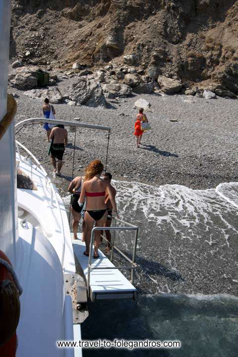 Katergo beach - Upon arrival to Katergo the tour boat approaches the beach and tourists descend from a ladder to the beach by Ioannis Matrozos